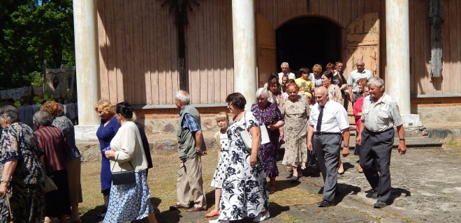 Visi, susirinkę į atlaidus, dalyvauja procesijoje aplink bažnyčią.